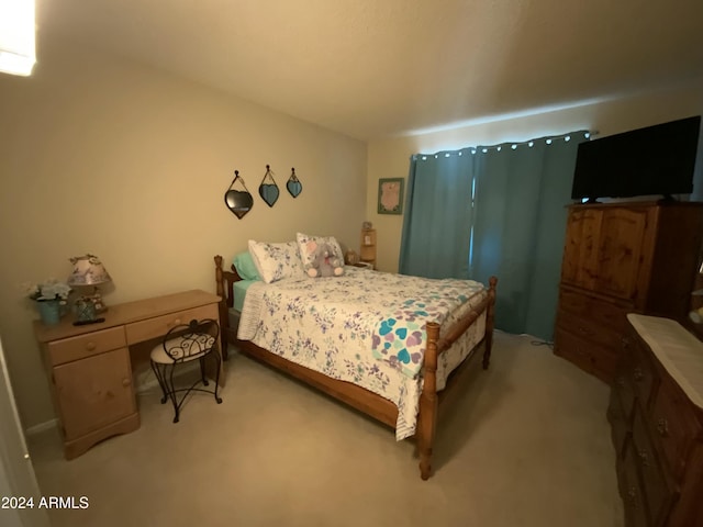 bedroom featuring light carpet