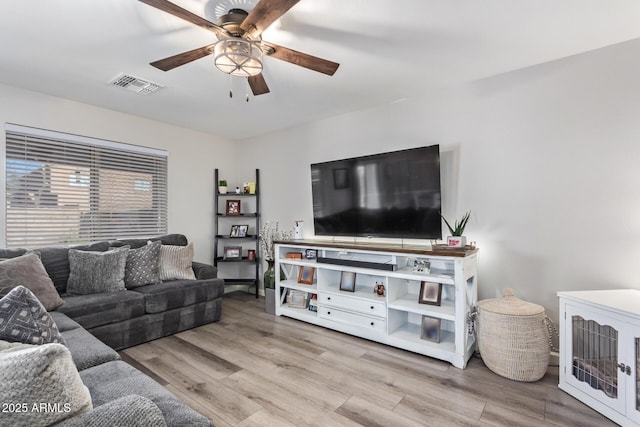 living room featuring light hardwood / wood-style flooring and ceiling fan