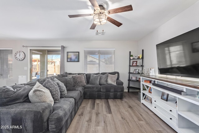 living room with ceiling fan and light wood-type flooring