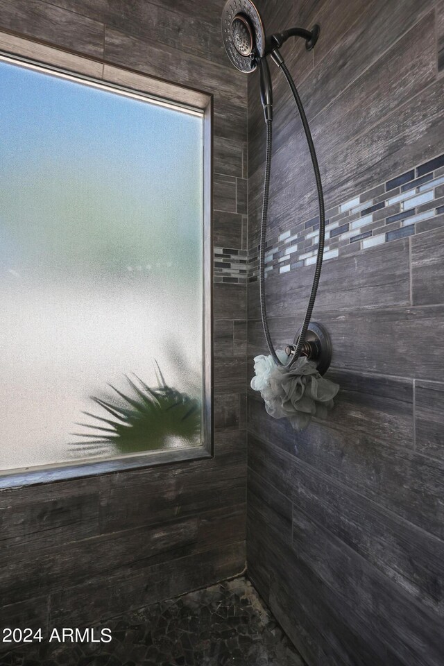 bathroom with a sink, double vanity, and a shower stall