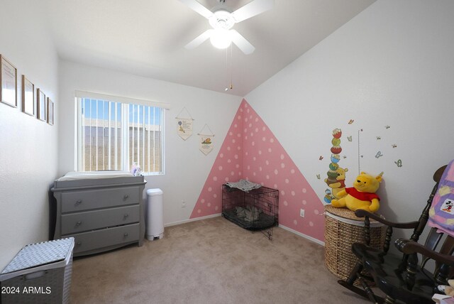 bedroom with a ceiling fan, vaulted ceiling, and carpet