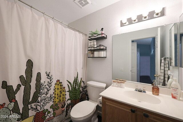 bedroom with visible vents, lofted ceiling, light carpet, arched walkways, and ensuite bath