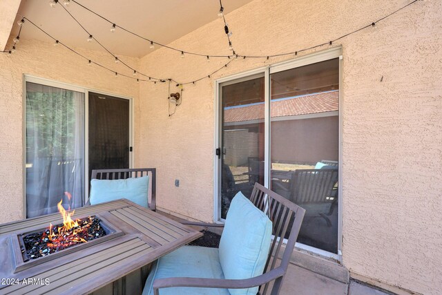 view of patio featuring an outdoor fire pit and fence