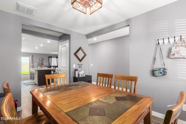 dining space with light wood-type flooring