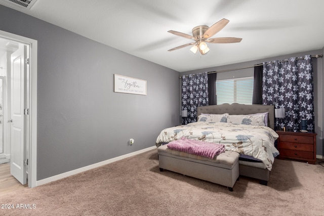 bedroom with ceiling fan and light colored carpet