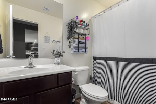 bathroom featuring vanity and toilet