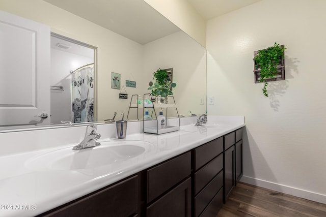 bathroom with hardwood / wood-style floors and vanity