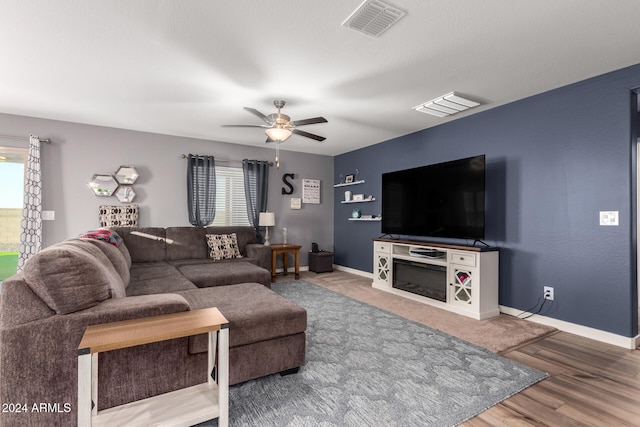 living room with hardwood / wood-style flooring, a wealth of natural light, and ceiling fan