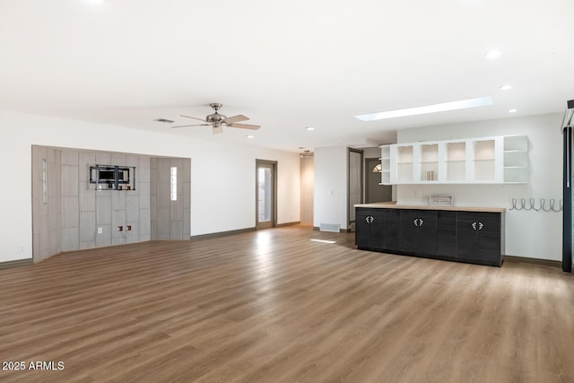 unfurnished living room with light wood finished floors, baseboards, visible vents, ceiling fan, and recessed lighting