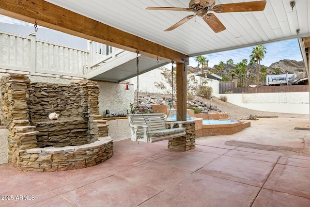 view of patio featuring ceiling fan and fence