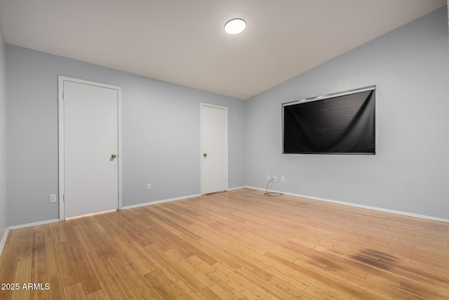5135 E Evergreen St Unit 1166, Mesa, AZ 85205 - unfurnished bedroom featuring light wood finished floors, baseboards, and vaulted ceiling