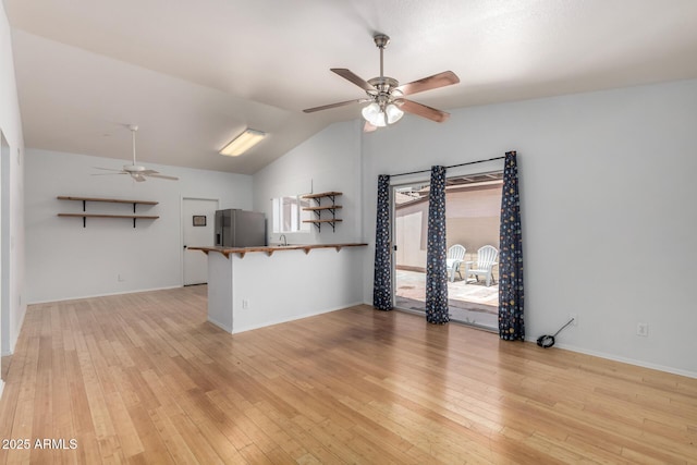 5135 E Evergreen St Unit 1166, Mesa, AZ 85205 - unfurnished living room with ceiling fan, lofted ceiling, light wood-style floors, and baseboards