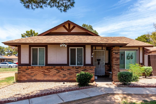 5135 E Evergreen St Unit 1166, Mesa, AZ 85205 - view of front of home with stucco siding, brick siding, and a shingled roof