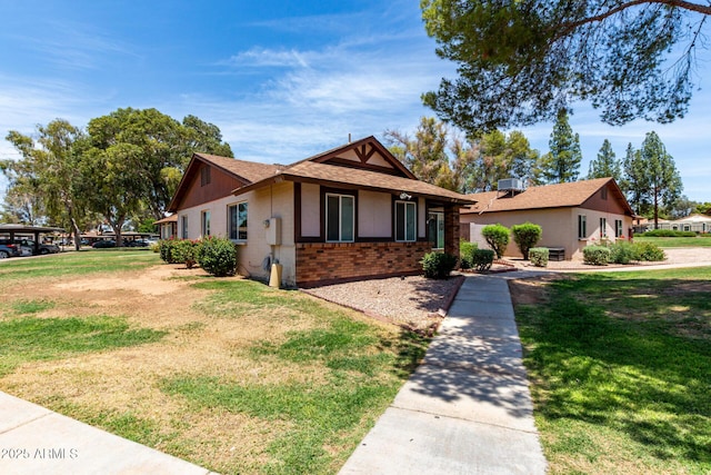 5135 E Evergreen St Unit 1166, Mesa, AZ 85205 - view of front of property with brick siding, a front lawn, and a shingled roof