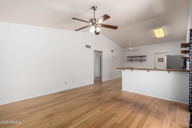 5135 E Evergreen St Unit 1166, Mesa, AZ 85205 - unfurnished living room featuring ceiling fan, vaulted ceiling, and light wood-type flooring
