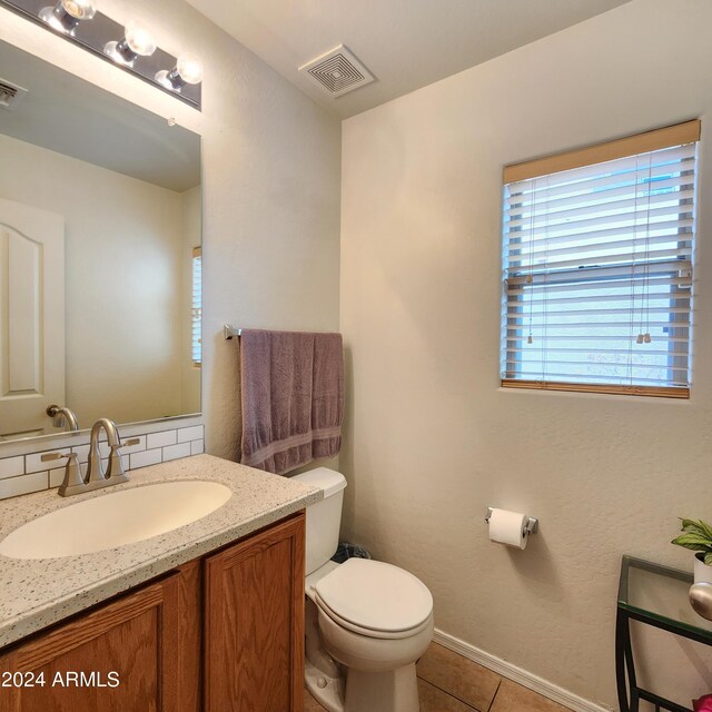 bathroom featuring tile patterned floors, vanity, and toilet