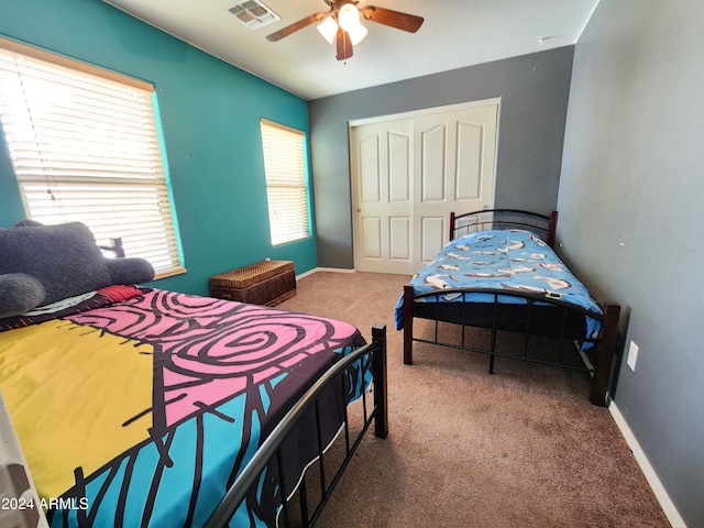 bedroom with carpet flooring, a closet, and ceiling fan