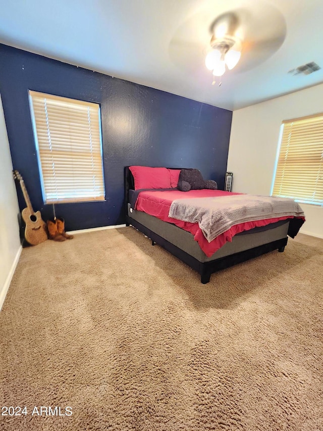 bedroom with ceiling fan and carpet