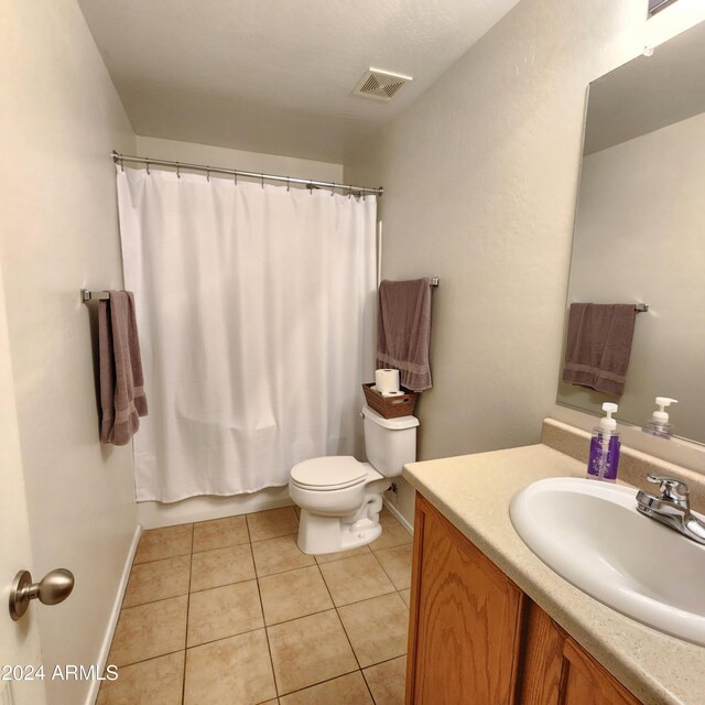 full bathroom with vanity, toilet, tile patterned floors, and shower / tub combo with curtain