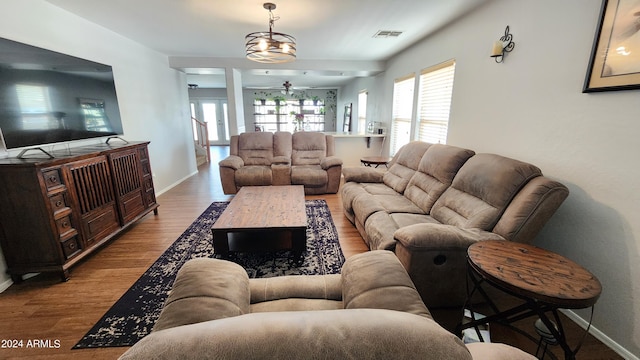 living room featuring ceiling fan and light hardwood / wood-style flooring