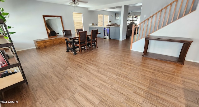 dining room with ceiling fan, light wood-type flooring, and wine cooler