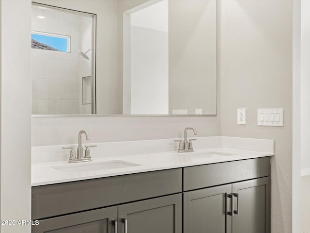 bathroom with vanity and a shower