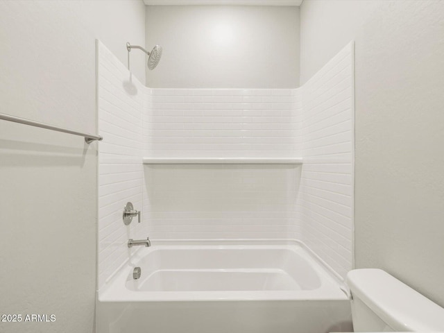 bathroom featuring shower / washtub combination and toilet