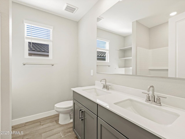 bathroom featuring vanity, hardwood / wood-style floors, and toilet