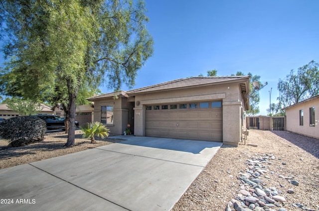 single story home featuring an attached garage, concrete driveway, stucco siding, and fence