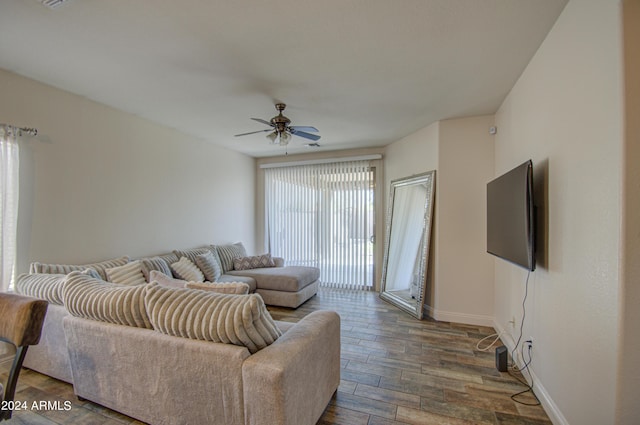 living area with baseboards, a ceiling fan, and wood finished floors