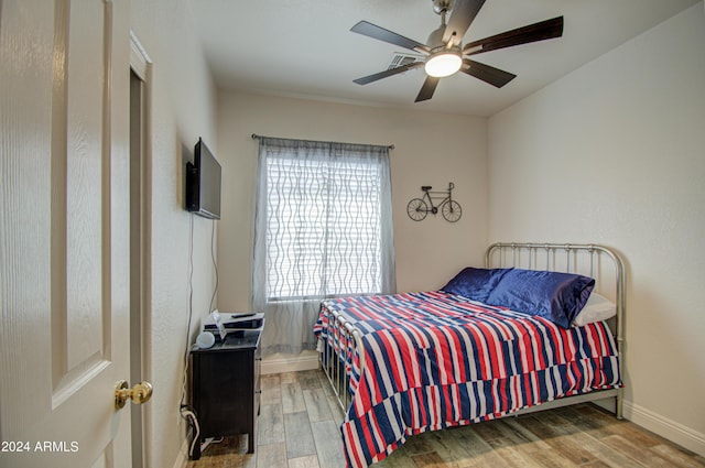 bedroom with baseboards, a ceiling fan, and wood finished floors