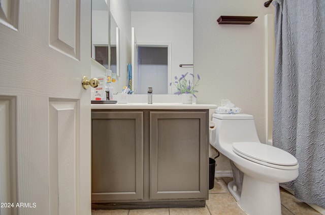 full bathroom featuring toilet, tile patterned floors, curtained shower, and vanity