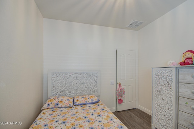 bedroom with visible vents, baseboards, and dark wood-style floors