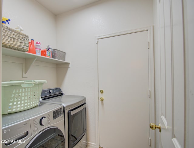 washroom featuring laundry area, tile patterned floors, and washer and clothes dryer