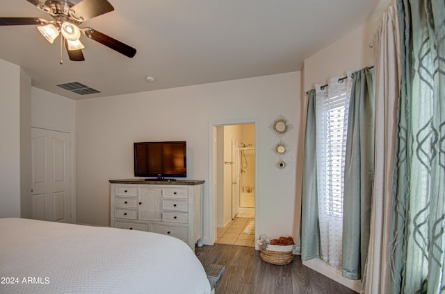 bedroom with ceiling fan, dark wood-style floors, and visible vents