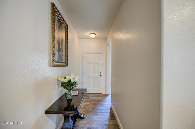 corridor with baseboards and dark wood finished floors