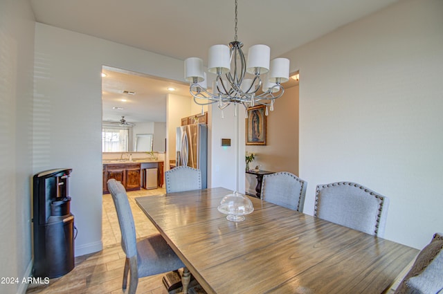 dining space featuring a chandelier and light wood-style floors