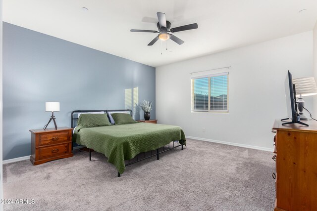 bedroom with light carpet and ceiling fan