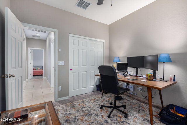 home office featuring light tile patterned flooring and ceiling fan