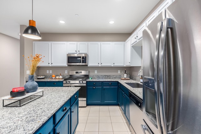 kitchen featuring pendant lighting, sink, white cabinets, appliances with stainless steel finishes, and blue cabinetry