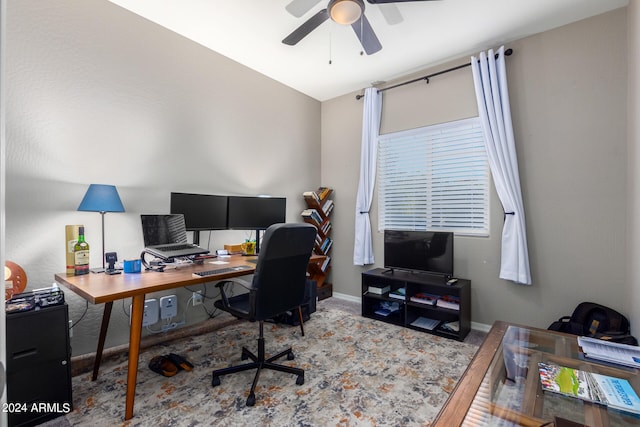 home office featuring ceiling fan, vaulted ceiling, and hardwood / wood-style floors