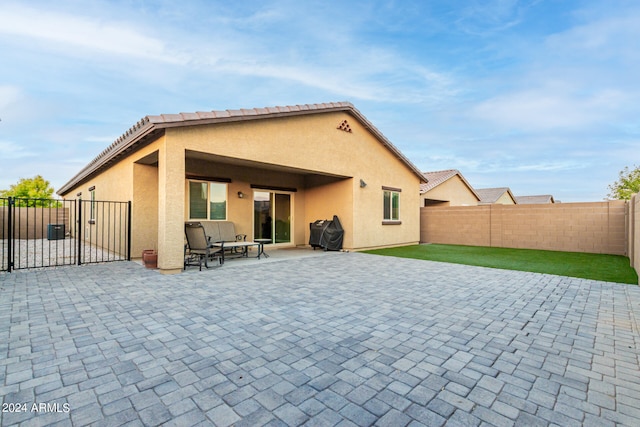 rear view of house featuring a patio