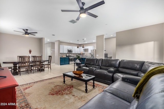 tiled living room with ceiling fan