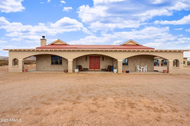 rear view of property featuring a patio