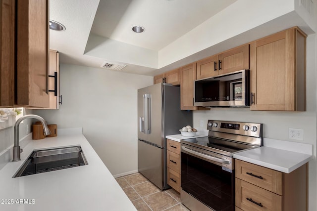 16336 E Palisades Blvd Unit 4, Fountain Hills, AZ 85268 - kitchen featuring stainless steel appliances, a sink, light countertops, a raised ceiling, and light tile patterned floors