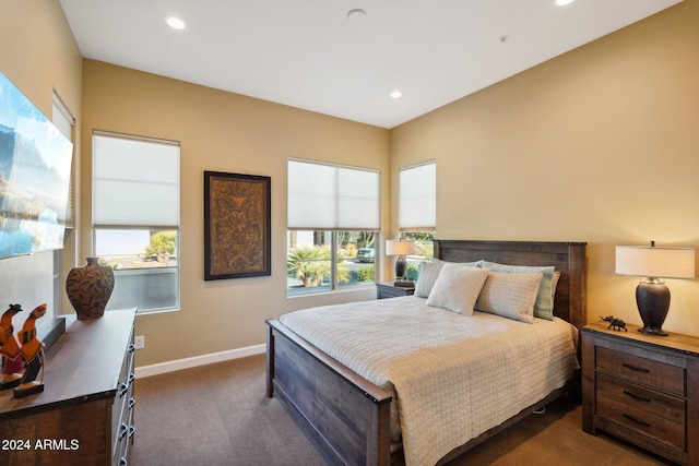 bedroom with dark colored carpet