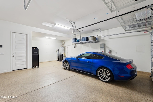 garage with gas water heater and a garage door opener