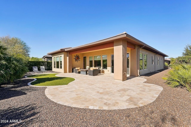 back of property featuring a patio area and an outdoor living space