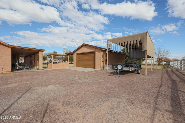 view of side of home with a garage and an outbuilding