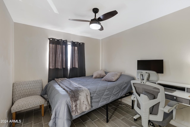 bedroom featuring dark hardwood / wood-style flooring and ceiling fan